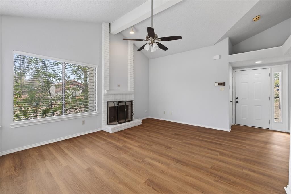 18040 Midway Road, Unit 195 Dallas, TX 75287 - Photo 7 of 17 a view of an empty room with a window and wooden floor