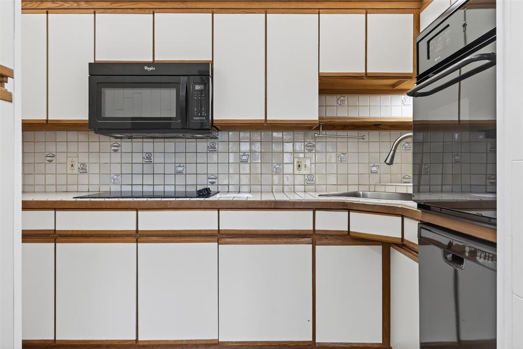 18040 Midway Road, Unit 195 Dallas, TX 75287 - Photo 10 of 17 a kitchen with stainless steel appliances a sink and cabinets