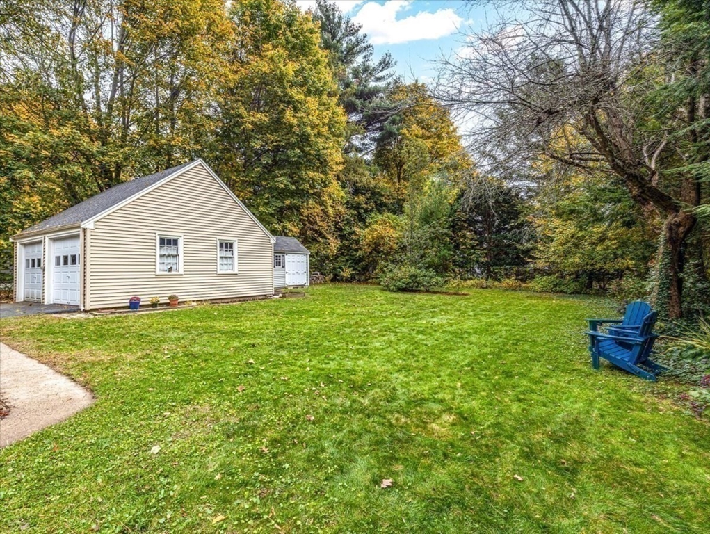 46 Park Street Dedham, MA 02026 - Photo 31 of 35 a view of a backyard with potted plants and large tree