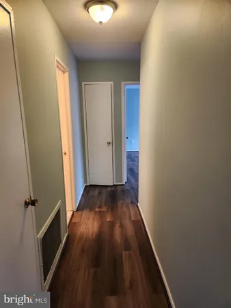 a view of room with window and wooden floor