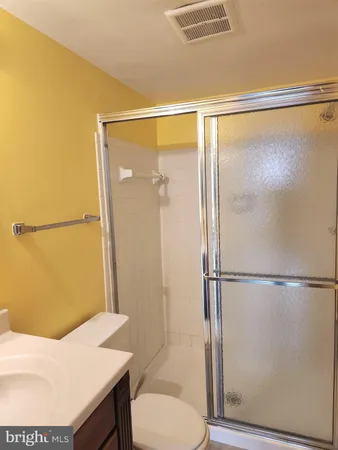 a bathroom with a shower and a toilet