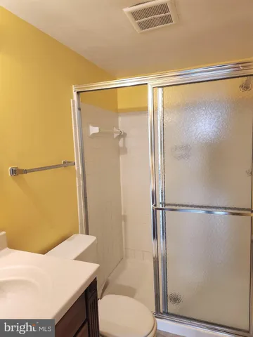 a bathroom with a shower and a toilet