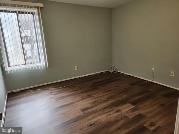 a view of a room with wooden floor and window