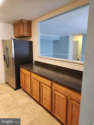a kitchen with stainless steel appliances granite countertop a sink stove and microwave