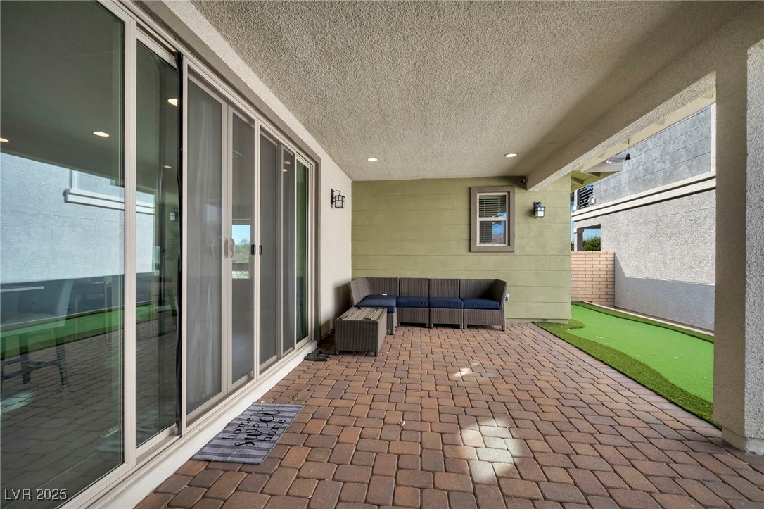 1012 East Sunset Road Henderson, NV 89011 - Photo 11 of 77 View of patio / terrace featuring an area to practice putting and outdoor lounge area