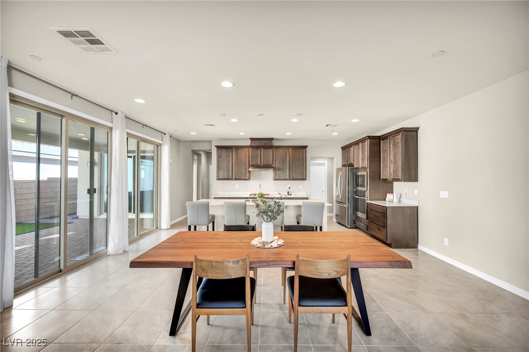 1012 East Sunset Road Henderson, NV 89011 - Photo 29 of 77 Dining space with recessed lighting and light tile patterned flooring