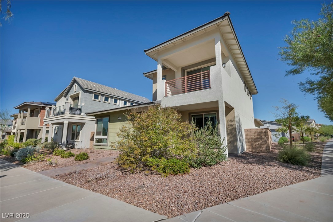 1012 East Sunset Road Henderson, NV 89011 - Photo 3 of 77 Contemporary house with a balcony and stucco siding