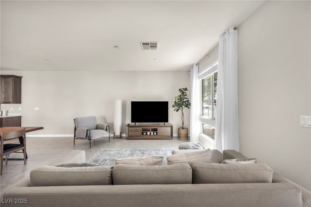 1012 East Sunset Road Henderson, NV 89011 - Photo 39 of 77 Living area with baseboards and light tile patterned flooring