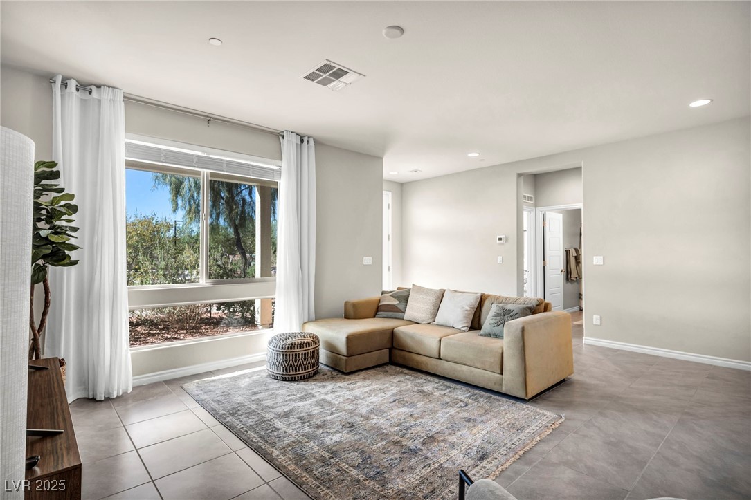 1012 East Sunset Road Henderson, NV 89011 - Photo 40 of 77 Tiled living room with recessed lighting and baseboards