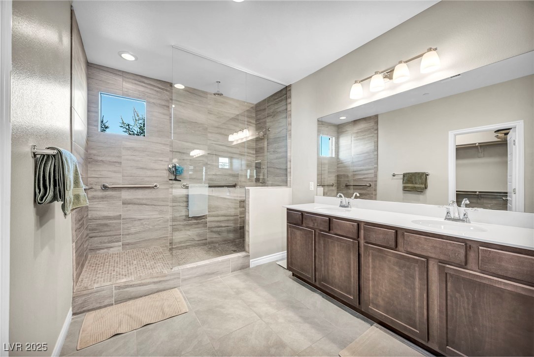 1012 East Sunset Road Henderson, NV 89011 - Photo 58 of 77 Bathroom with a walk in closet, double vanity, a walk in shower, light tile patterned floors, and recessed lighting