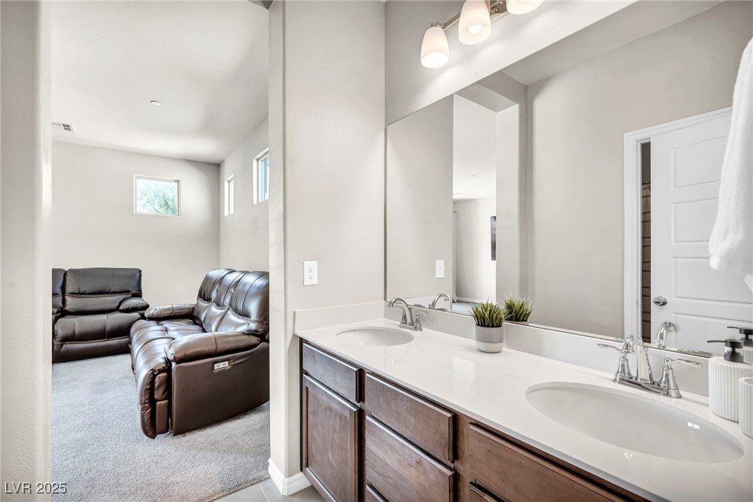 1012 East Sunset Road Henderson, NV 89011 - Photo 67 of 77 Bathroom featuring light carpet, double vanity, and ensuite bath