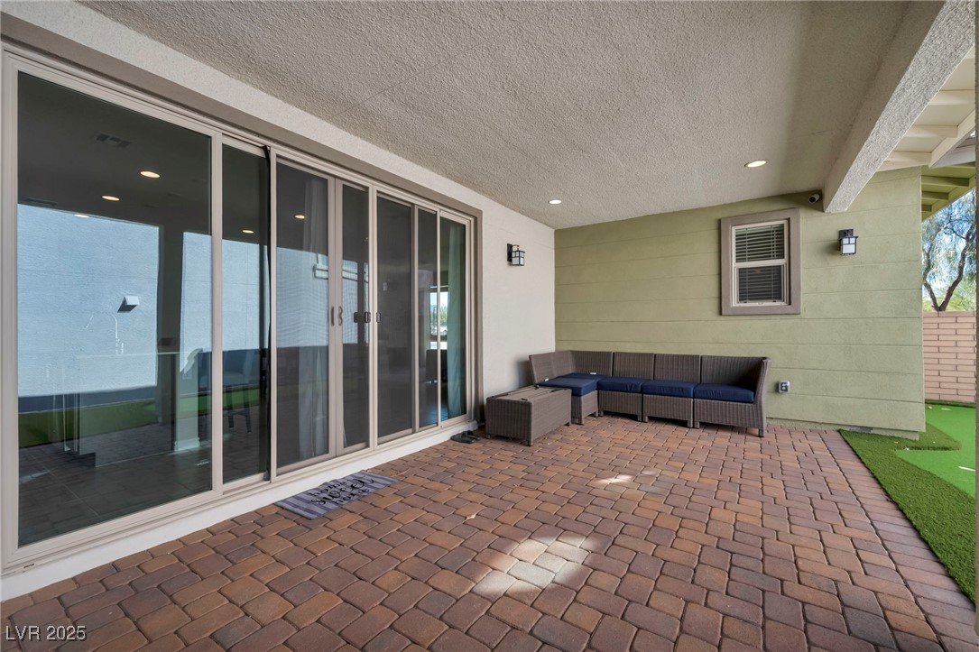 1012 East Sunset Road Henderson, NV 89011 - Photo 10 of 77 View of patio with an outdoor living space and a putting green