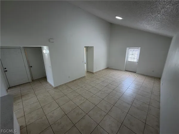 a kitchen with a sink a stove and white cabinets