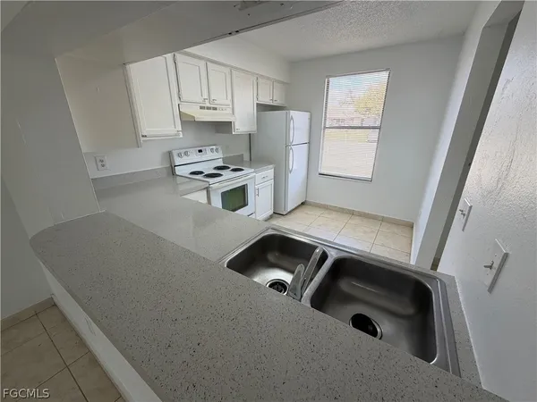 a kitchen with a cabinets and white appliances