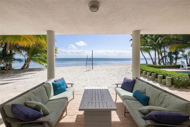 a view of a house with a swimming pool and sitting area