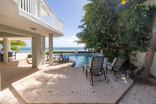 a view of a patio with swimming pool table and chairs