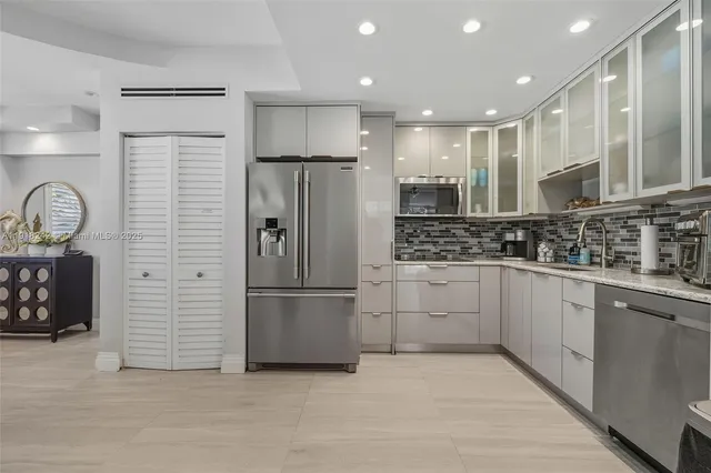 a view of a patio with a dining table and chairs with wooden floor