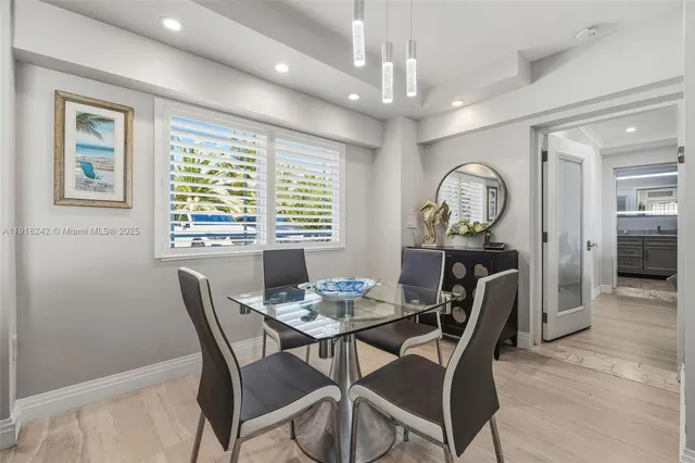 a view of a patio with couches table and chairs and potted plants