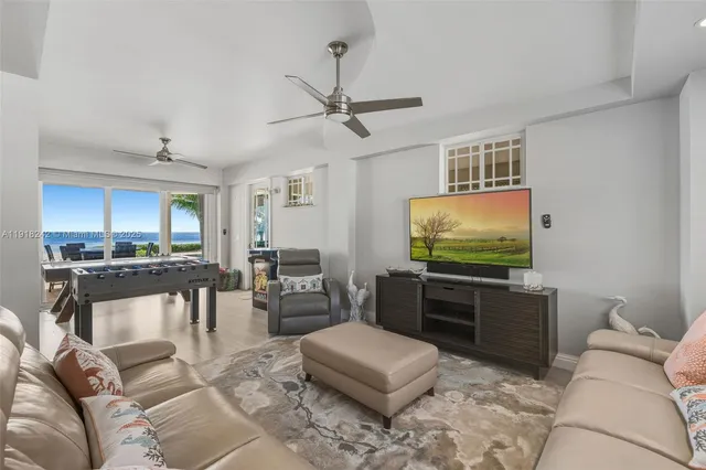 a dining hall with stainless steel appliances granite countertop a table and chairs