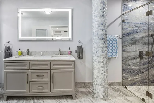 a kitchen with stainless steel appliances granite countertop a refrigerator a stove a sink a dining table and chairs with wooden floor