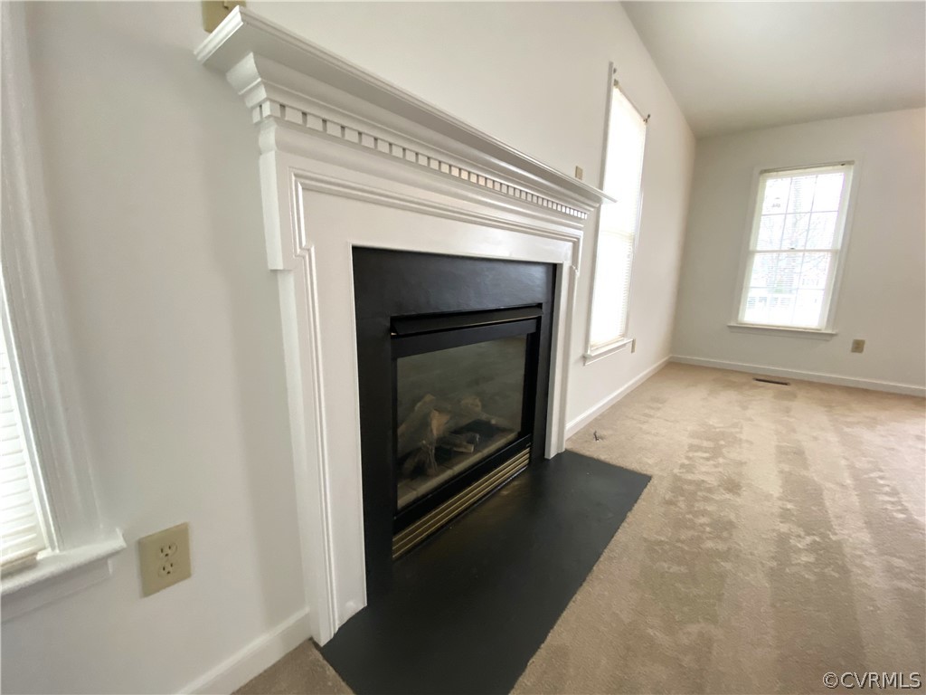 5137 Hackney Road Richmond, VA 23234 - Photo 4 of 43 an empty room with wooden floor fireplace and windows