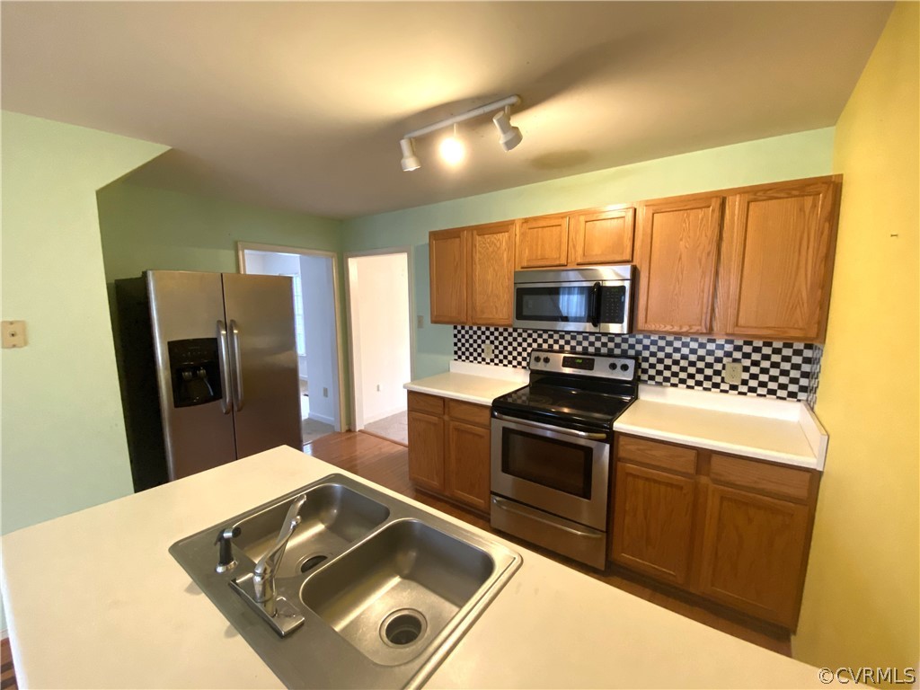 5137 Hackney Road Richmond, VA 23234 - Photo 10 of 43 a kitchen with stainless steel appliances granite countertop a sink stove and refrigerator