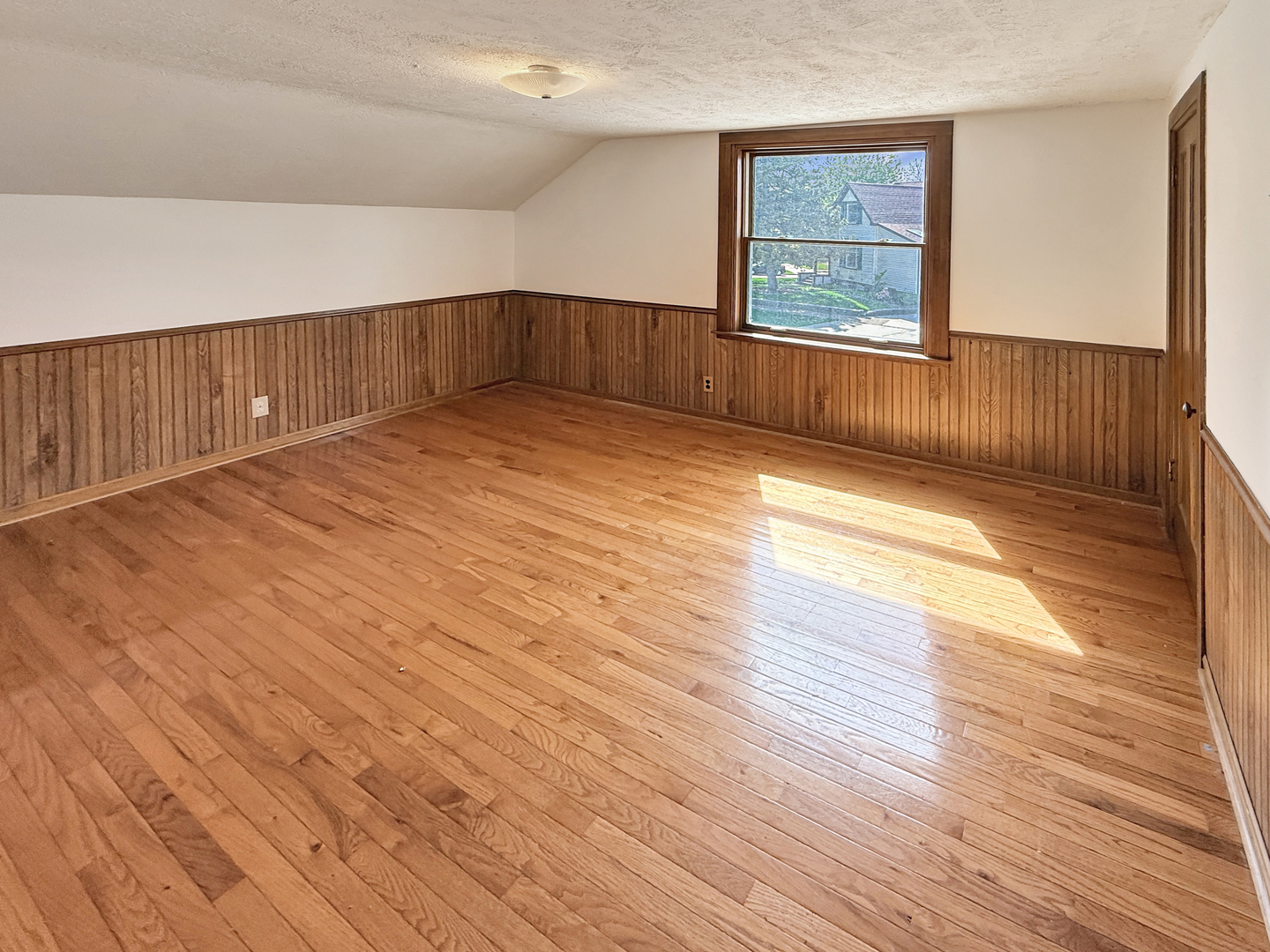511 Chestnut Street Waukegan, IL 60085 - Photo 11 of 17 a view of an empty room with wooden floor and a window
