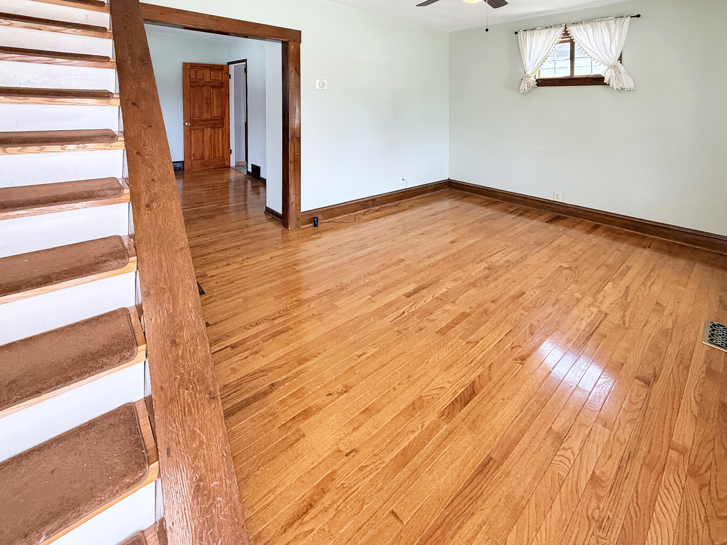 511 Chestnut Street Waukegan, IL 60085 - Photo 3 of 17 a view of empty room with wooden floor and fan