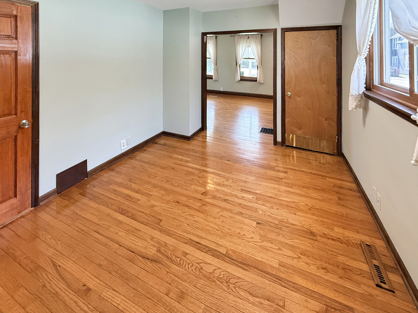 511 Chestnut Street Waukegan, IL 60085 - Photo 5 of 17 wooden floor in an empty room with a window