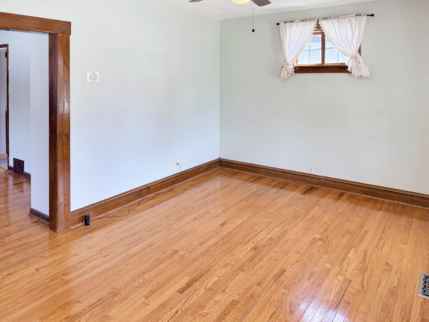 511 Chestnut Street Waukegan, IL 60085 - Photo 6 of 17 an empty room with wooden floor and windows