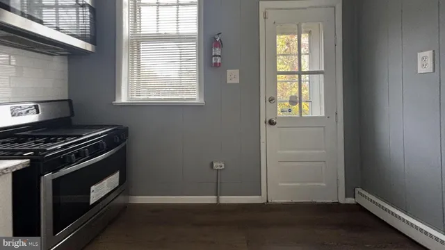 a kitchen with a stove and a window