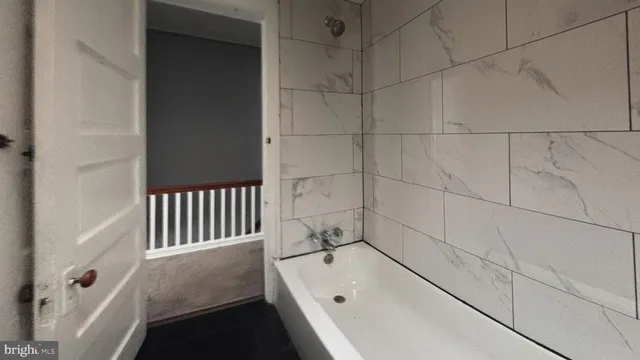 a bathroom with a bathtub and shower