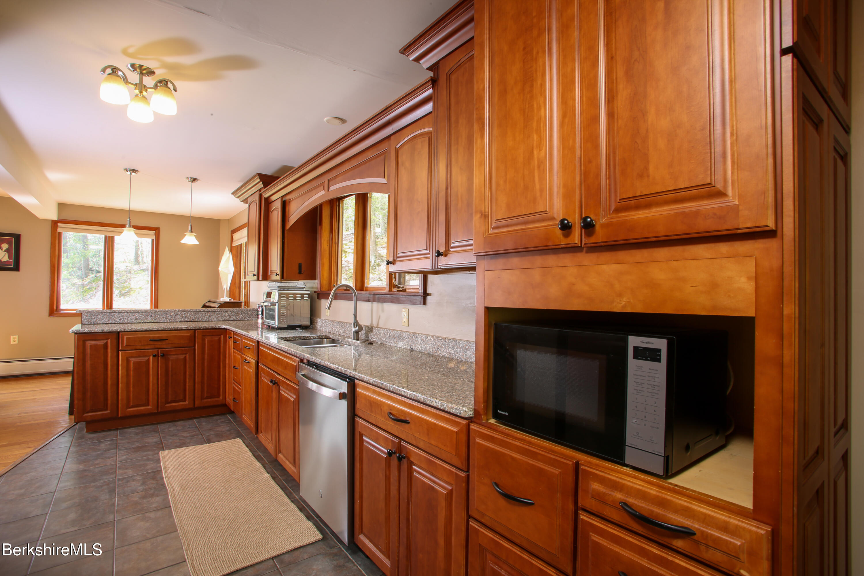 421 Legate Hill Road Charlemont, MA 01339 - Photo 13 of 37 a kitchen with stainless steel appliances granite countertop a stove a sink and a microwave