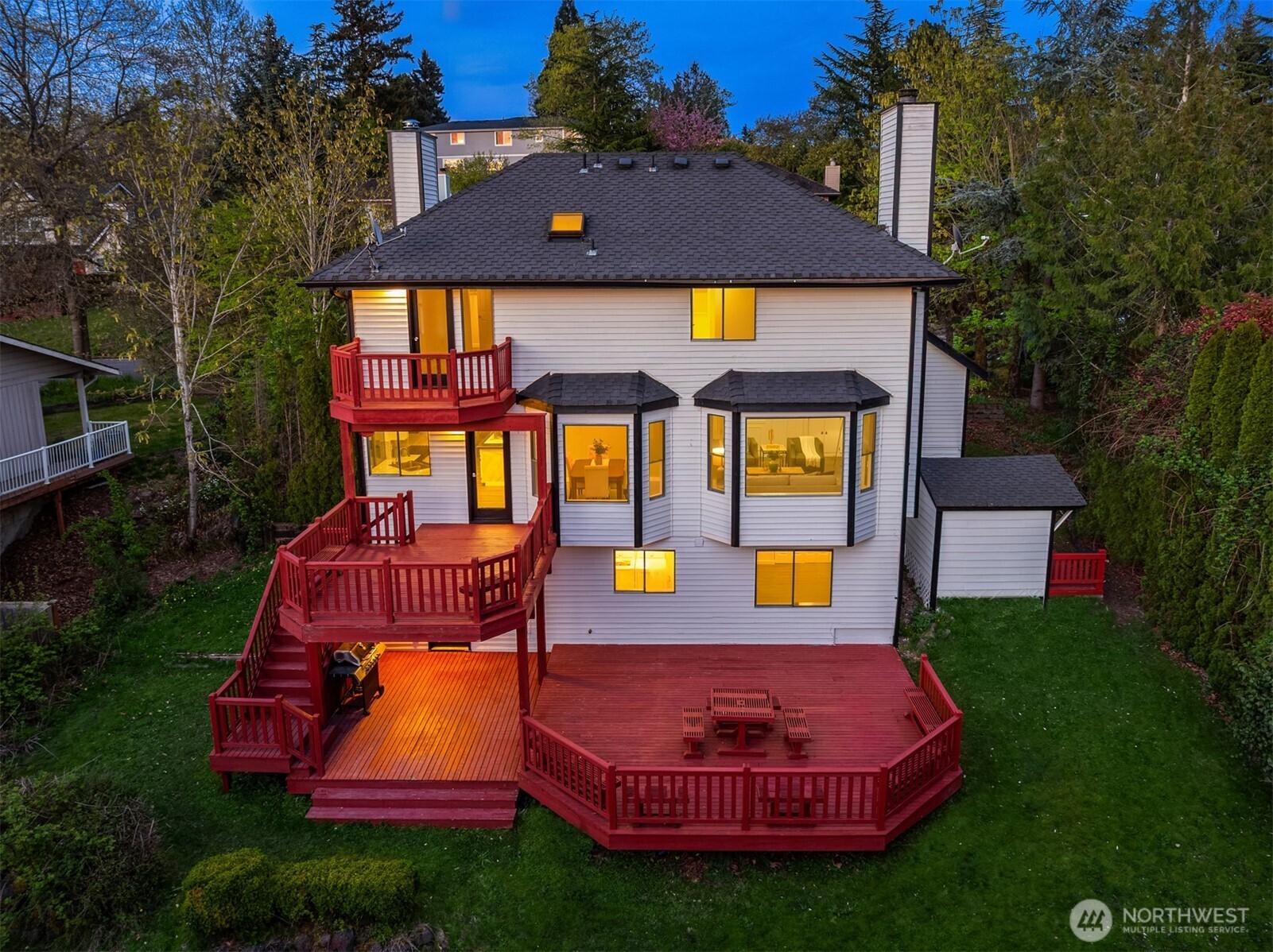 a aerial view of a house with swimming pool lawn chairs and a yard