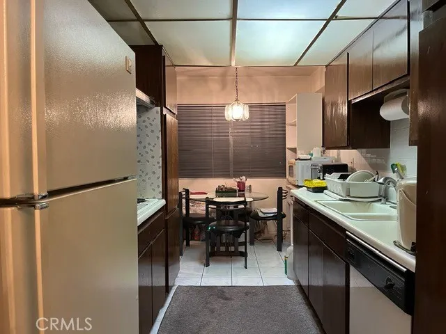 a kitchen with stainless steel appliances granite countertop a sink a stove and cabinets