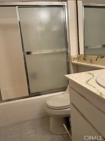 a bedroom with a bed and a chair