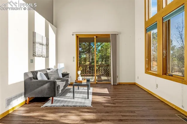a living room with furniture and a floor to ceiling window