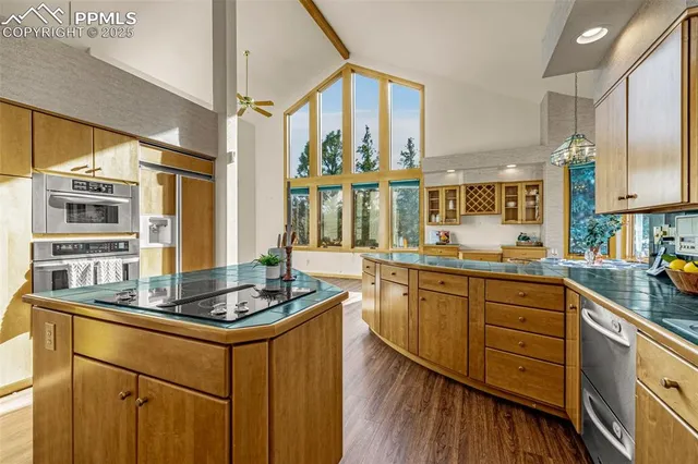 a kitchen with stainless steel appliances granite countertop a stove a sink and a refrigerator