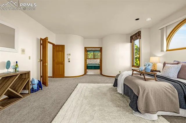 a bedroom with furniture and a lamp