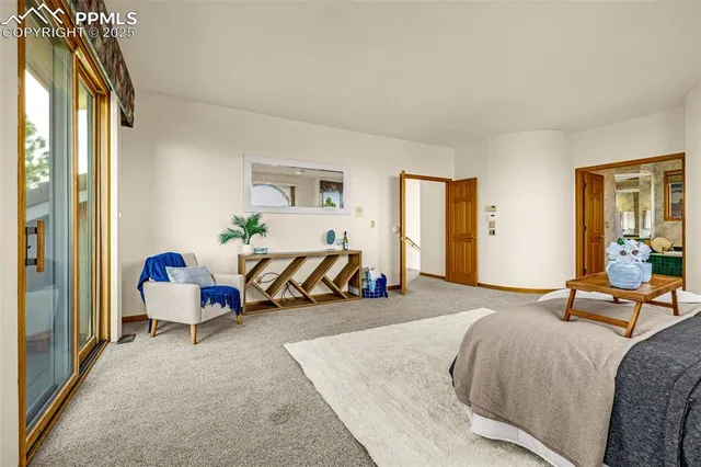 a bedroom with a bed a table and chair