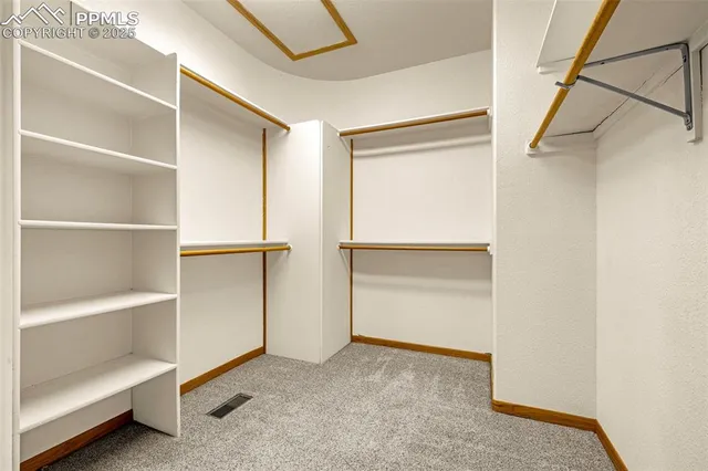 a kitchen with stainless steel appliances granite countertop a stove top oven a sink dishwasher and white cabinets with wooden floor