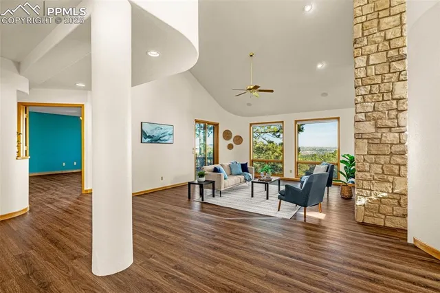 a living room with furniture and wooden floor