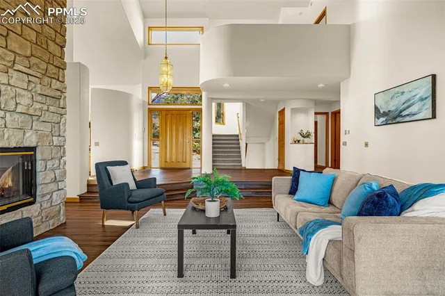 a living room with furniture and a chandelier