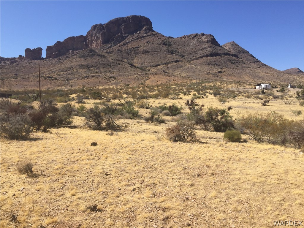 1565 Gilbert Road Golden Valley, AZ 86413 - Photo 1 of 6 a view of a yard of snow and mountain