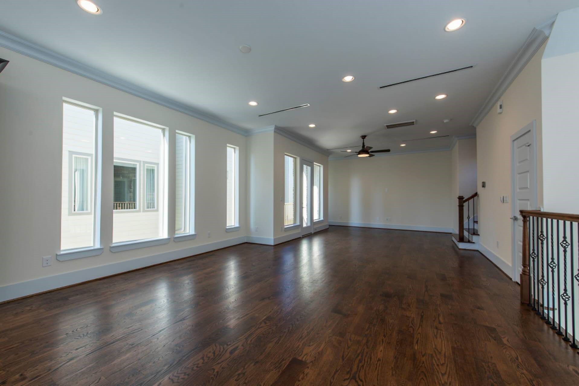 1805 Rosedale Street Houston, TX 77004 - Photo 13 of 27 a view of an empty room with wooden floor and a window