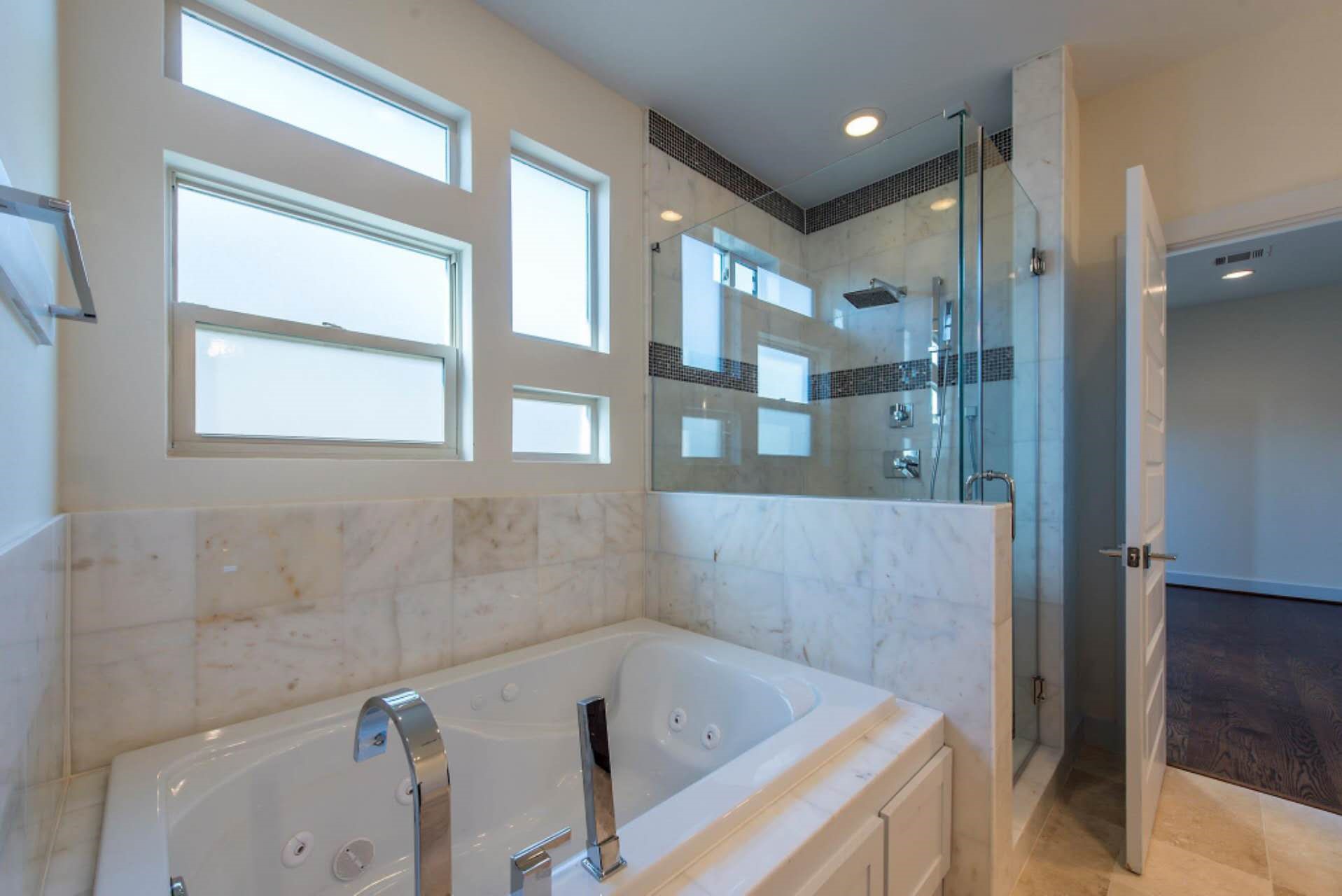 1805 Rosedale Street Houston, TX 77004 - Photo 15 of 27 a bathroom with a bathtub and a shower