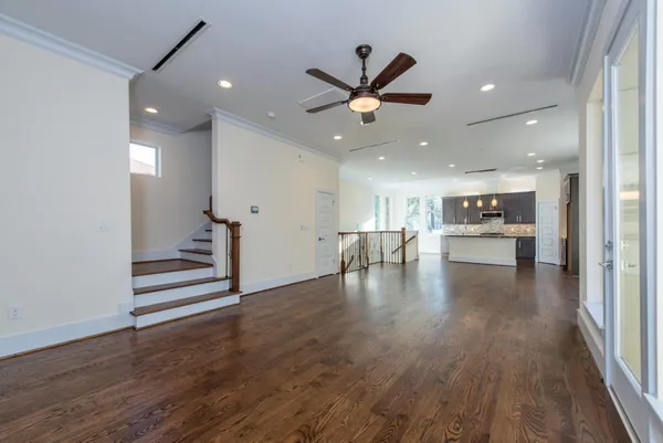 a view of an empty room and wooden floor