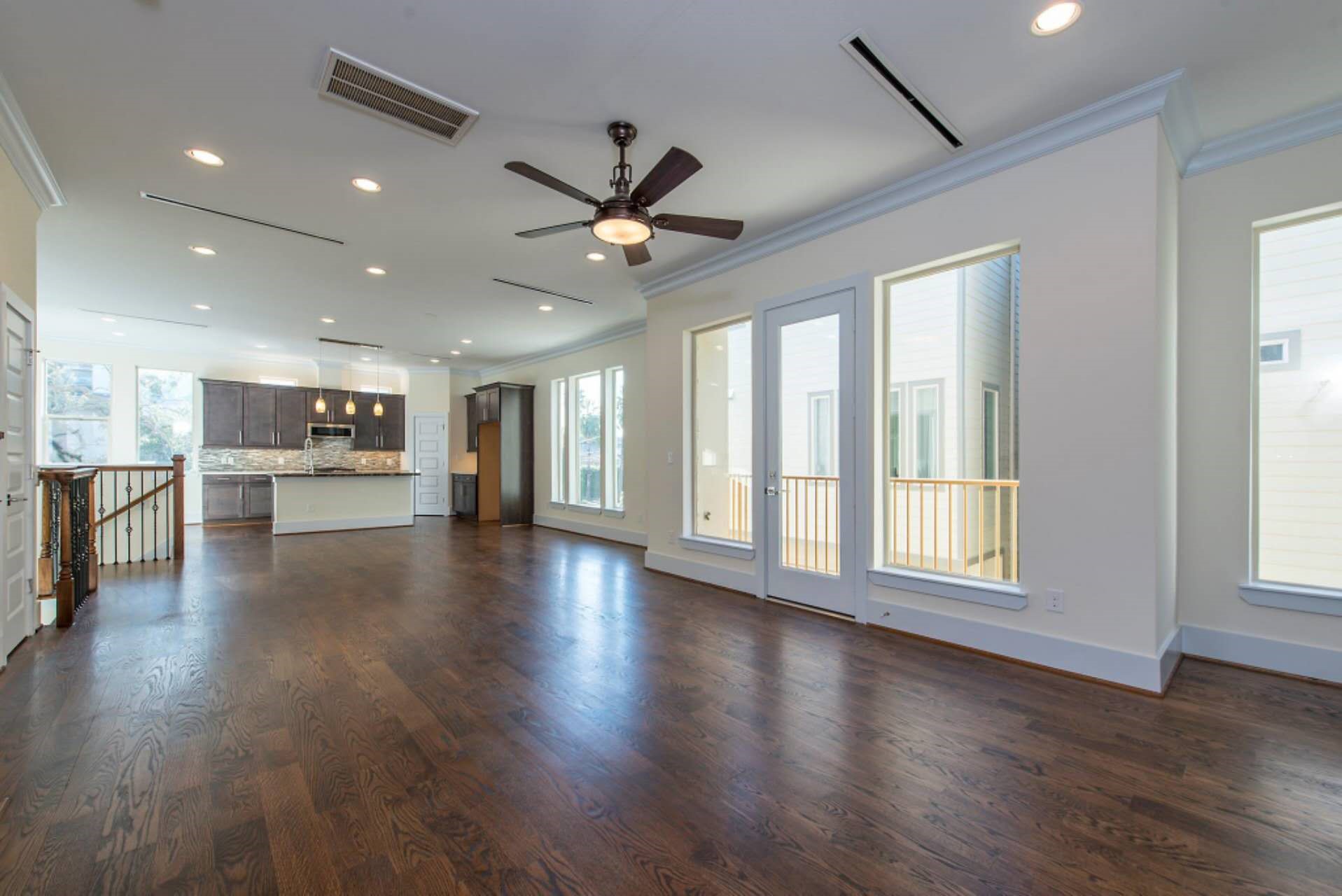 1805 Rosedale Street Houston, TX 77004 - Photo 17 of 27 a view of an empty room with a kitchen and wooden floor