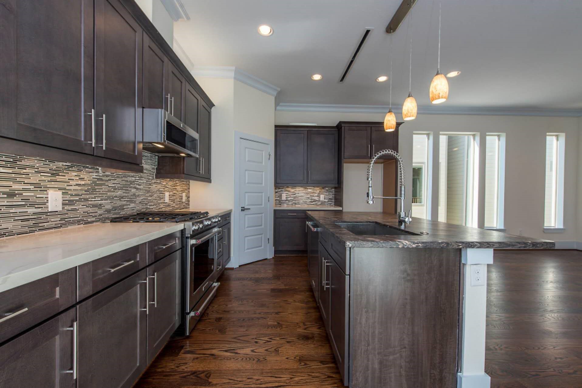 1805 Rosedale Street Houston, TX 77004 - Photo 18 of 27 a kitchen with stainless steel appliances granite countertop a stove a sink and a refrigerator
