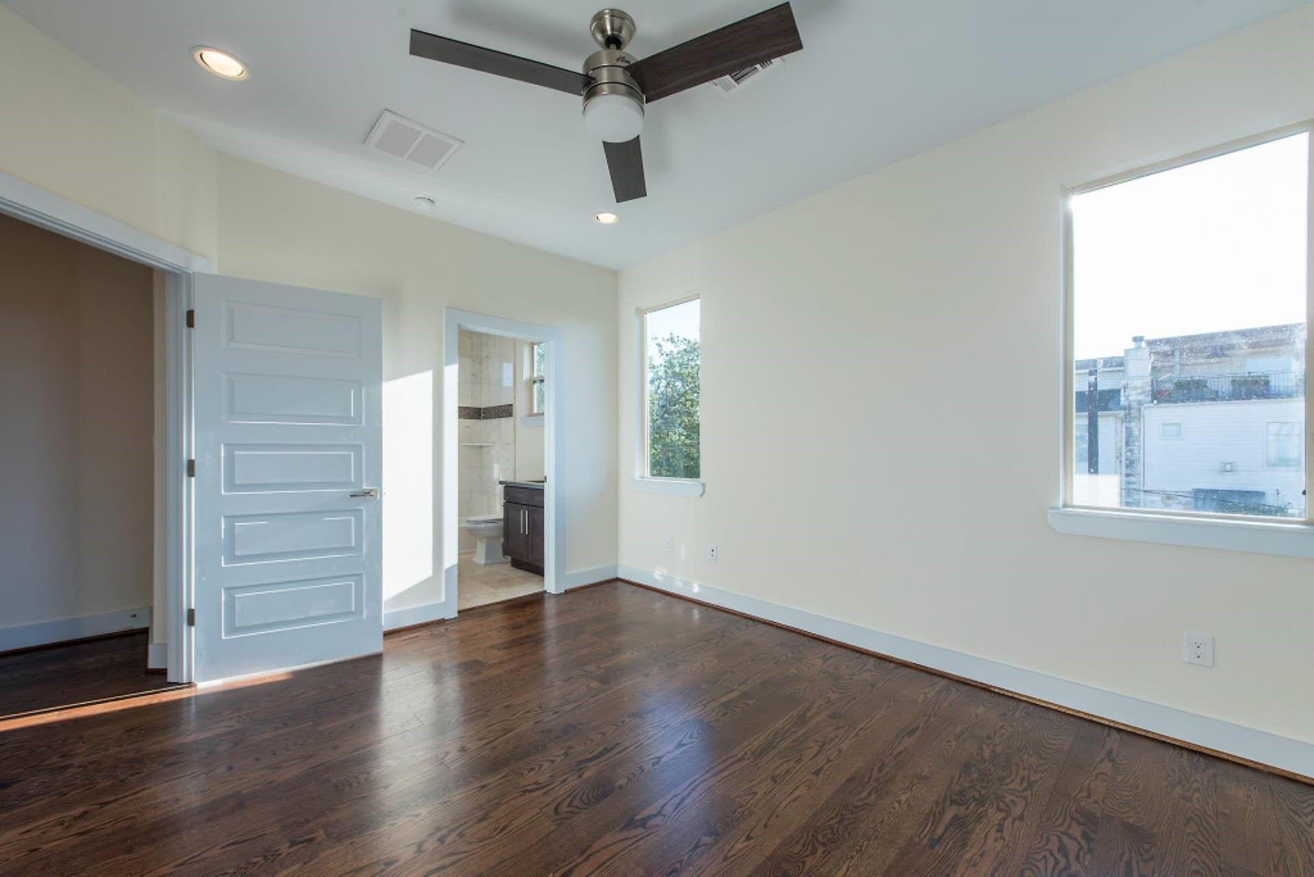1805 Rosedale Street Houston, TX 77004 - Photo 22 of 27 an empty room with wooden floor cabinet and windows